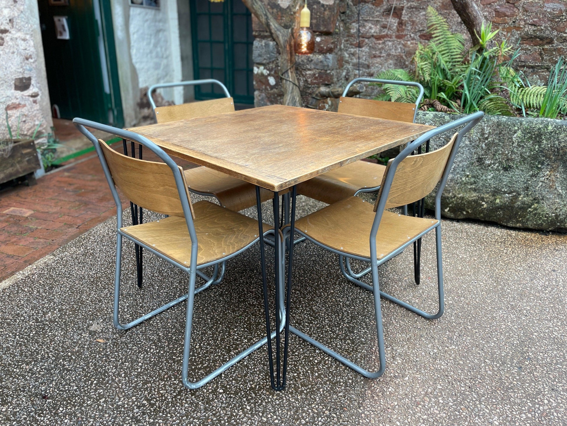 four bent steel and birch play stackable dining chairs with oak table